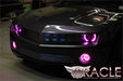 Front end of a Chevrolet Camaro with pink LED headlight and fog light halo rings installed.