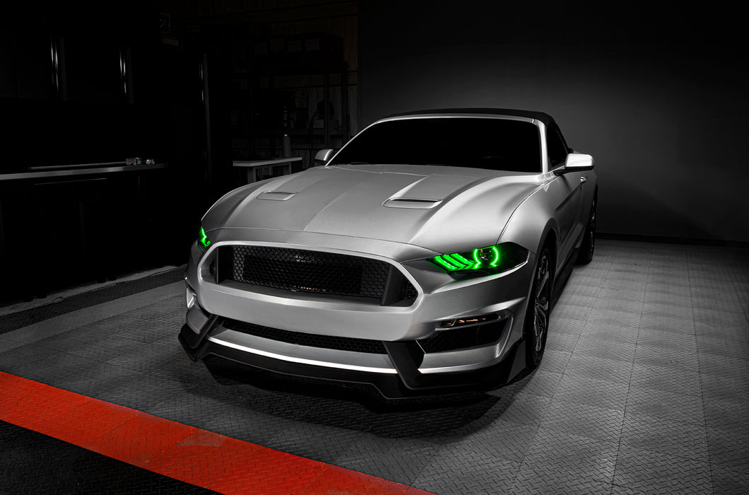 Three quarters view of a Ford Mustang with green headlight halos and DRLs.
