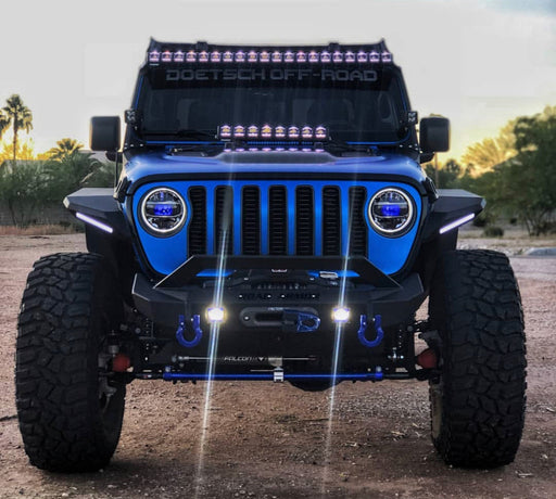 Blue Jeep Wrangler JL with multiple aftermarket lighting products installed, including the "Demon Eye" ColorSHIFT Projector Illumination Kit.