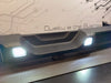 Rear Bumper LED Reverse Lights for Jeep Wrangler JL installed on a detached Jeep bumper.