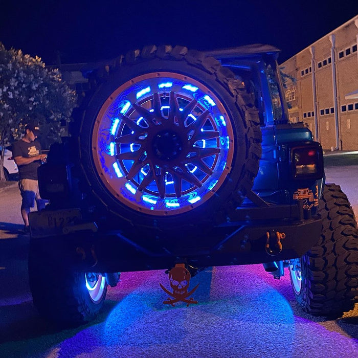 Rear end of a Jeep with blue LED Illuminated Spare Tire Wheel Ring Third Brake Light installed.