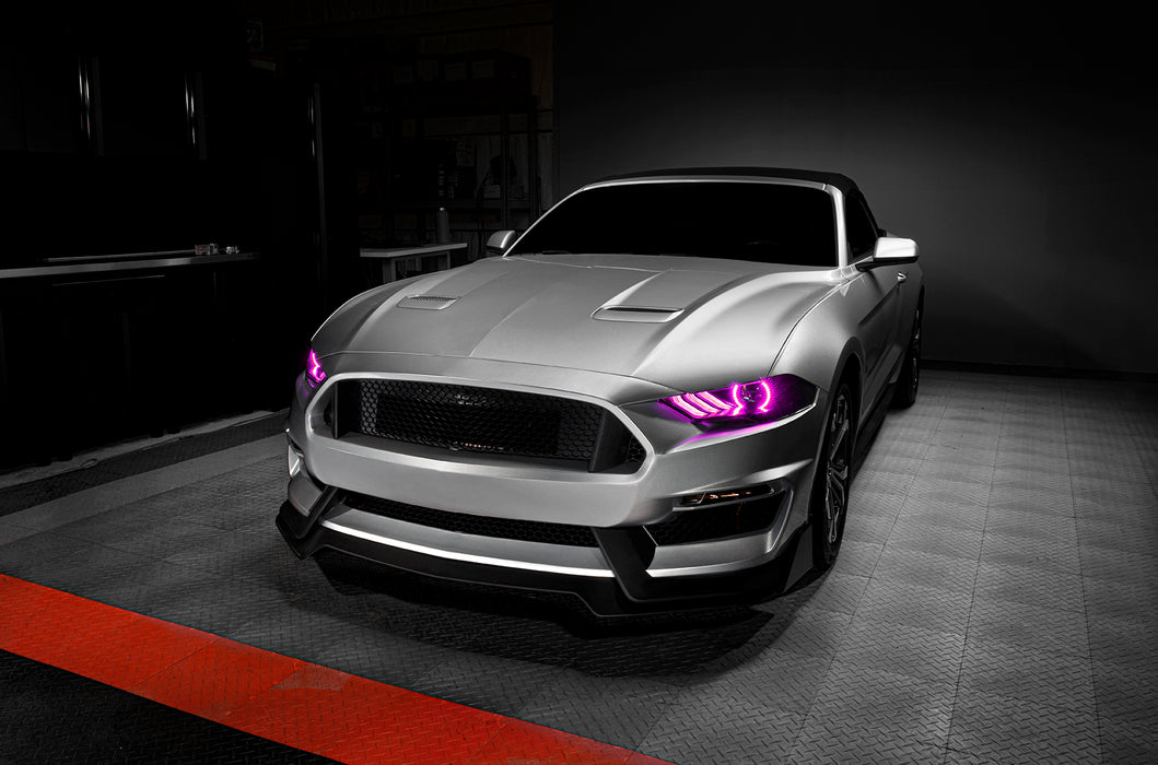 Three quarters view of a Ford Mustang with pink headlight halos and DRLs.