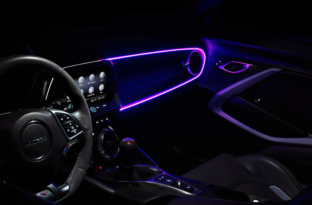 Car interior with purple fiber optic lighting installed on the dashboard.