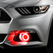 Close-up on the front bumper of a silver Ford Mustang equipped with red fog light halos.