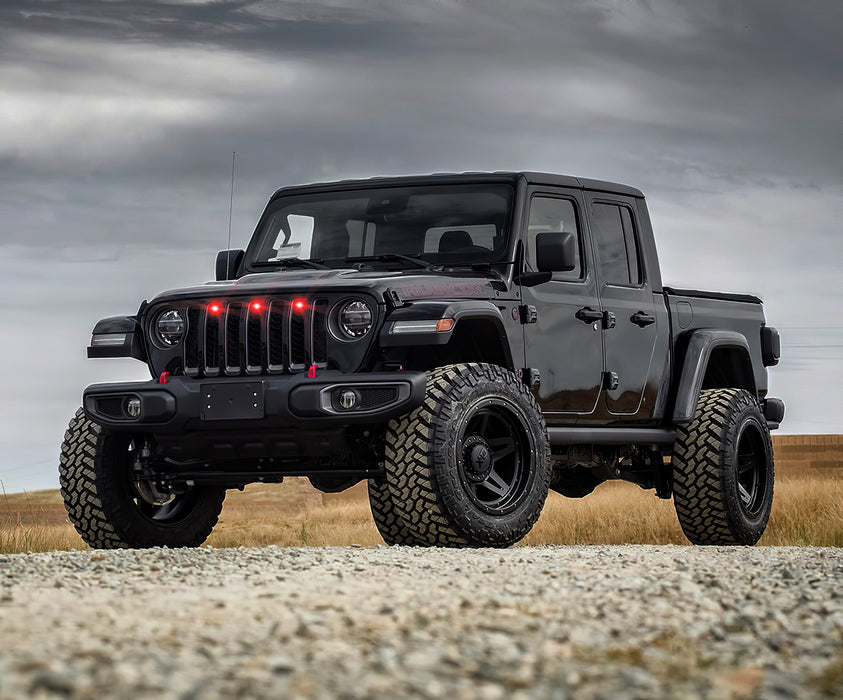 Lifestyle image of a Jeep Gladiator JT with red Pre-Runner Style LED Grill Light Kit installed.