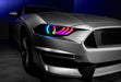 Close-up on a Ford Mustang headlight with rainbow halos and DRLs.