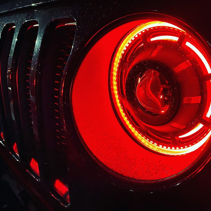 Close-up on a ColorSHIFT Oculus Headlight installed on a Jeep, with red halo rings.