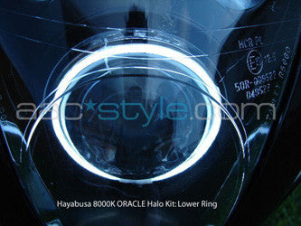 Suzuki Hayabusa headlight unit with white LED halo rings installed.