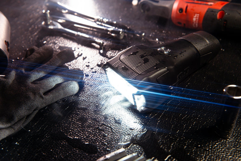 Introducing the ORACLE Vega Series 2 Flashlight on a workbench with tools, highlighting its bright performance in a compact design.