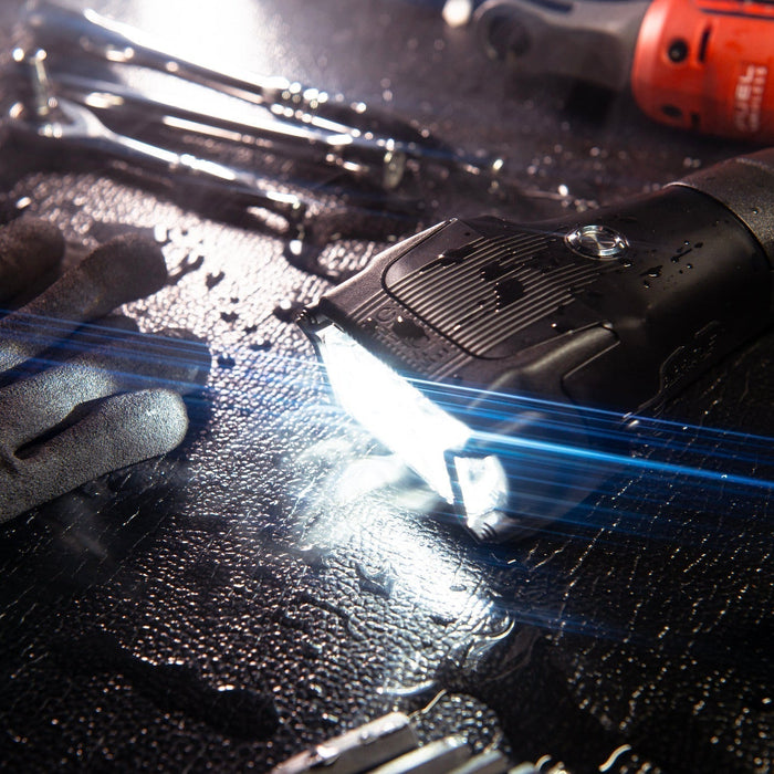 Introducing the ORACLE Vega Series 2 Flashlight on a workbench with tools, highlighting its bright performance in a compact design.