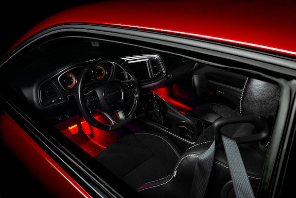 Valentine's Gifts for Car Guys represented by a red car with red footwell lights