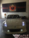 Front end of a Nissan 370Z with white LED headlight halo rings installed.
