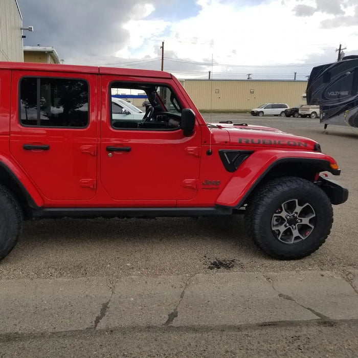 Side view of a red Jeep with Sidetrack™ LED Lighting System installed.