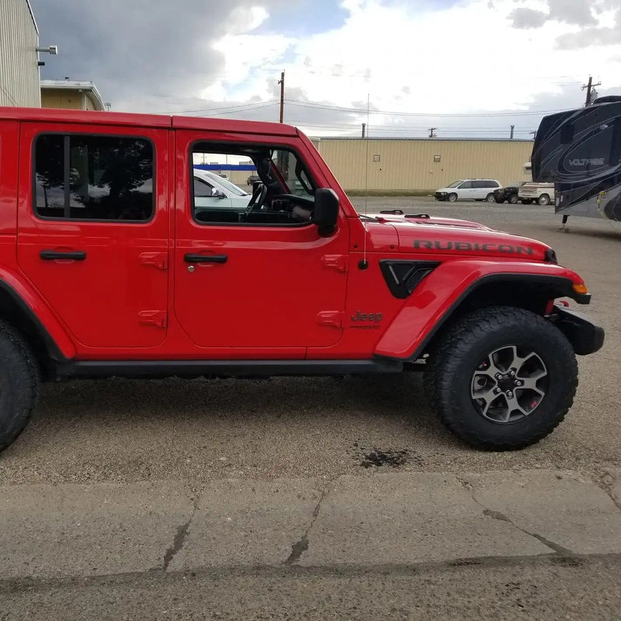 Side view of a red Jeep with Sidetrack™ LED Lighting System installed.