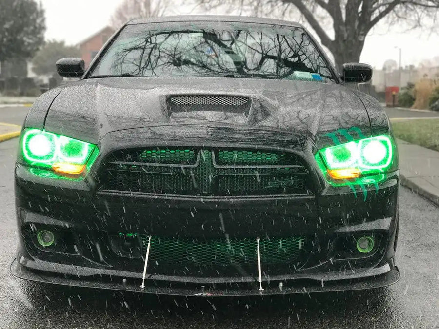 Front end of a black Dodge Charger with green LED headlight halo rings installed.