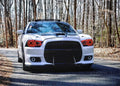 Front end of a white Dodge Charger with red LED headlight halo rings installed.