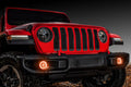 Red Jeep Gladiator with amber fog light halos installed.