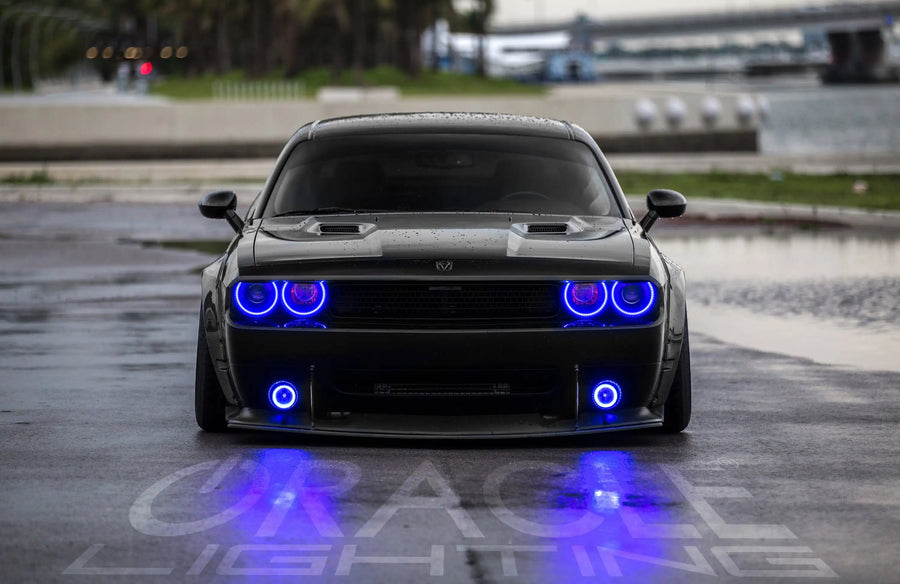 Front end of a Dodge Challenger with blue LED headlight and fog light halo rings.