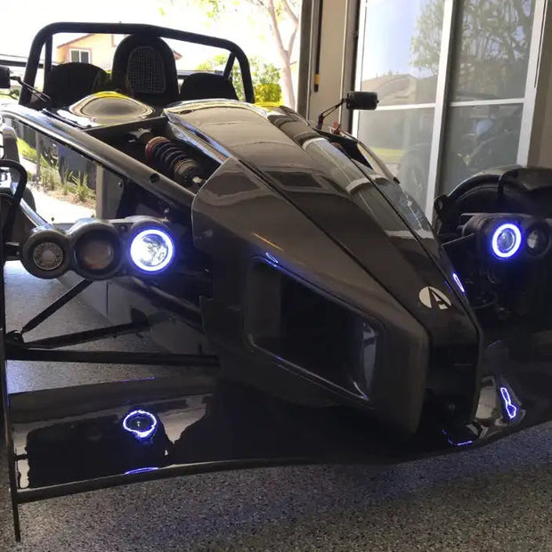 Ariel Atom with white headlight halos.