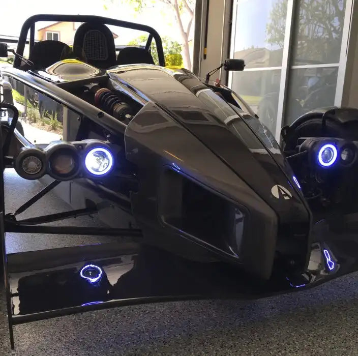 Ariel Atom with white headlight halos.