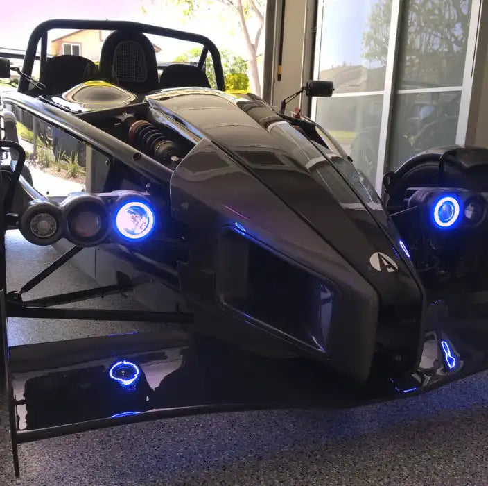 Ariel Atom with blue headlight halos.