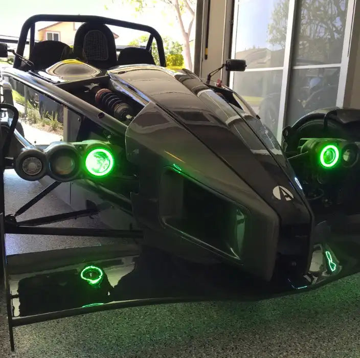 Ariel Atom with green headlight halos.