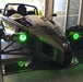 Ariel Atom with green headlight halos.