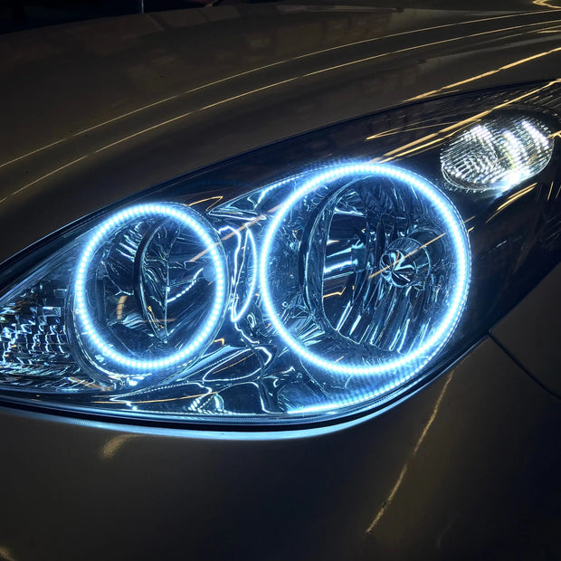 Close-up of a Lexus ES 300 headlight with white halos.