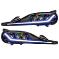 Toyota Supra headlights with white DRLs.