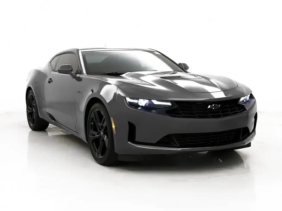 Three quarters view of a Chevrolet Camaro with white headlight DRLs.