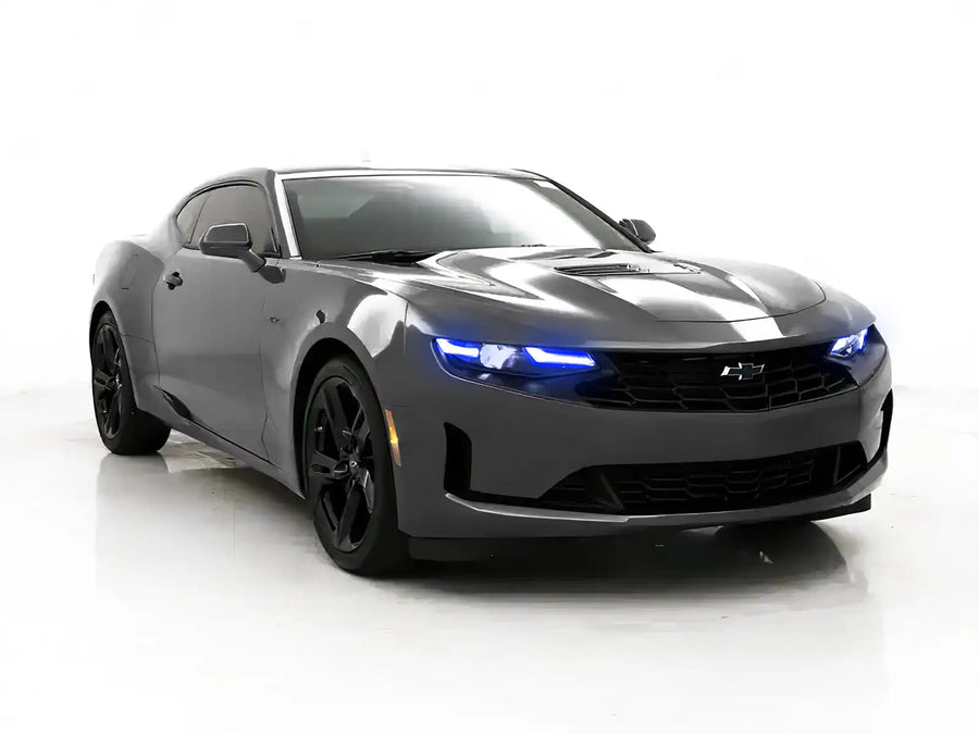 Three quarters view of a Chevrolet Camaro with blue headlight DRLs.