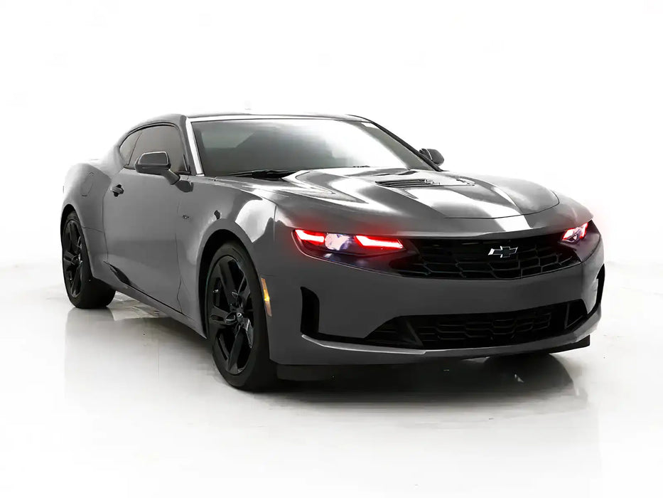 Three quarters view of a Chevrolet Camaro with red headlight DRLs.