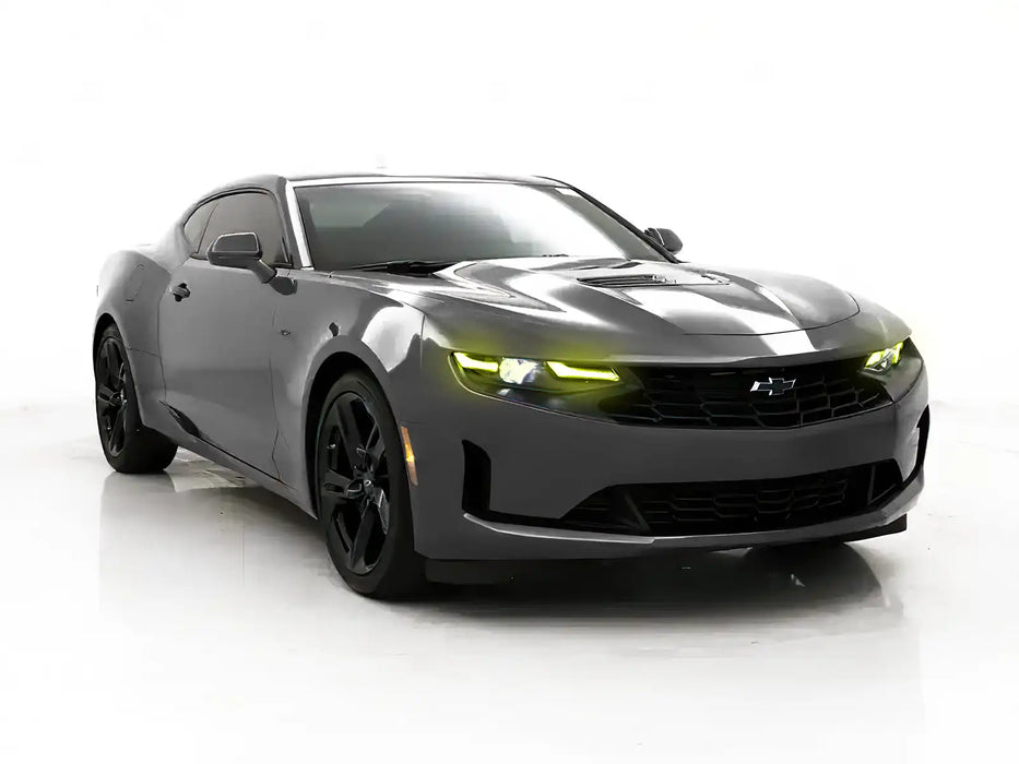 Three quarters view of a Chevrolet Camaro with yellow headlight DRLs.