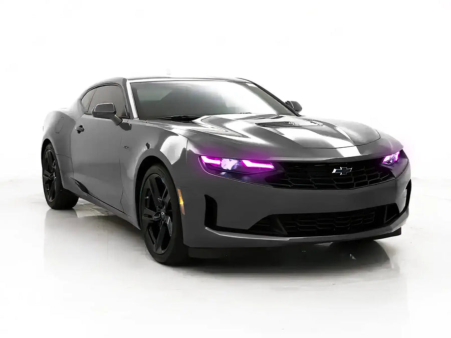 Three quarters view of a Chevrolet Camaro with pink headlight DRLs.
