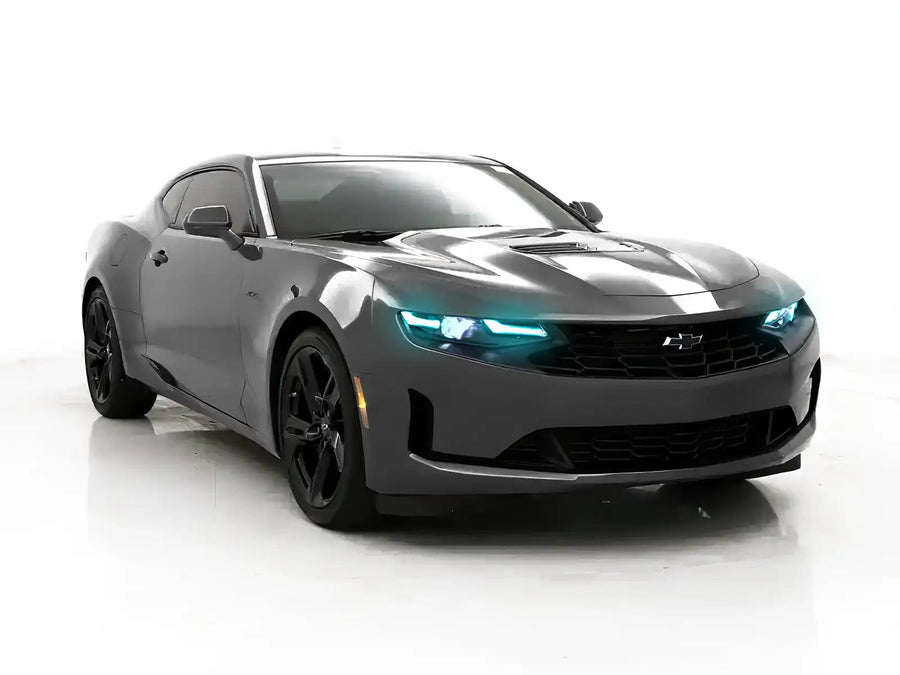 Three quarters view of a Chevrolet Camaro with cyan headlight DRLs.