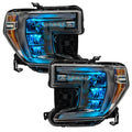 GMC Sierra 1500 headlights with cyan demon eye projectors.