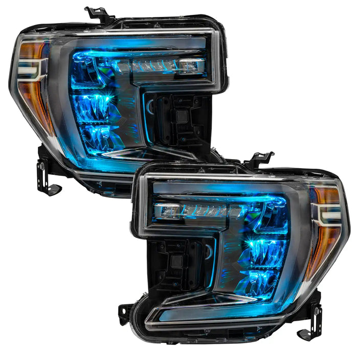 GMC Sierra 1500 headlights with cyan demon eye projectors.