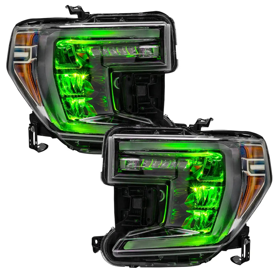 GMC Sierra 1500 headlights with green demon eye projectors.