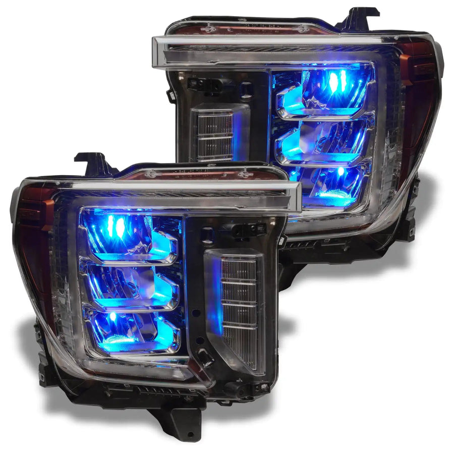 GMC Sierra headlights with cyan demon eye projectors.