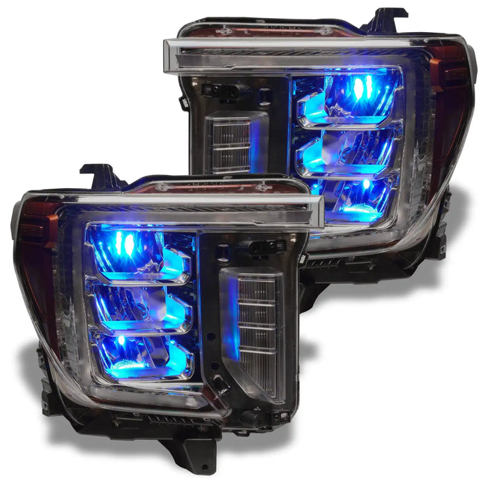 GMC Sierra headlights with cyan demon eye projectors.