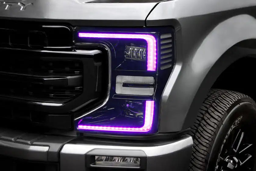 Close-up of a Ford Superduty headlight with pink DRLs.