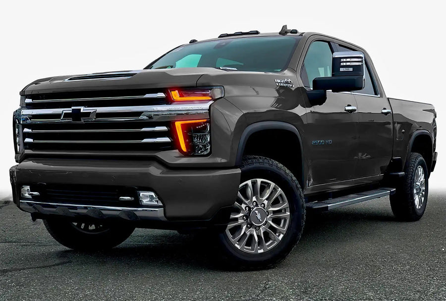 Three quarters view of a Chevy Silverado with amber headlight DRLs.