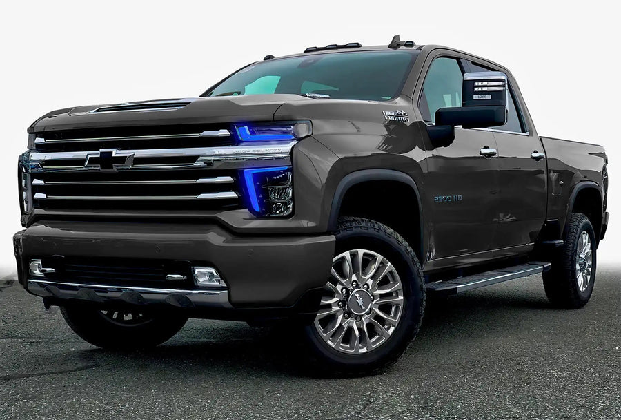Three quarters view of a Chevy Silverado with blue headlight DRLs.