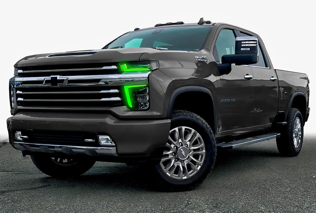 Three quarters view of a Chevy Silverado with green headlight DRLs.