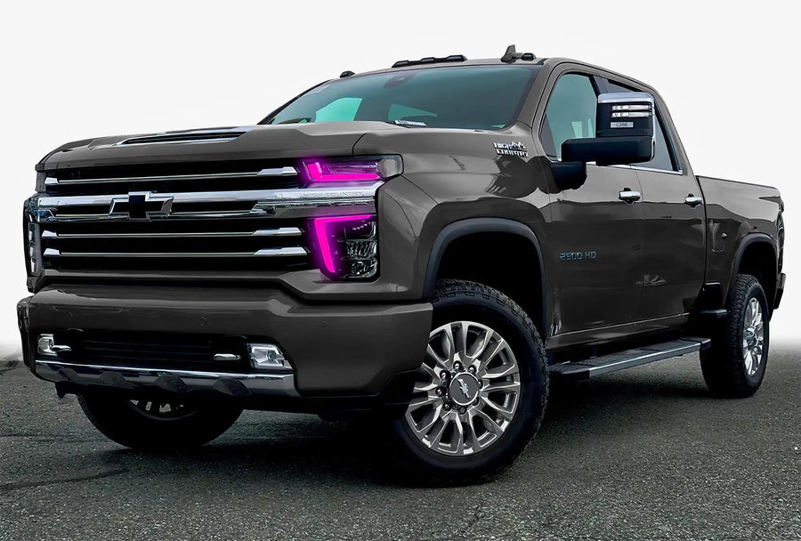 Three quarters view of a Chevy Silverado with pink headlight DRLs.
