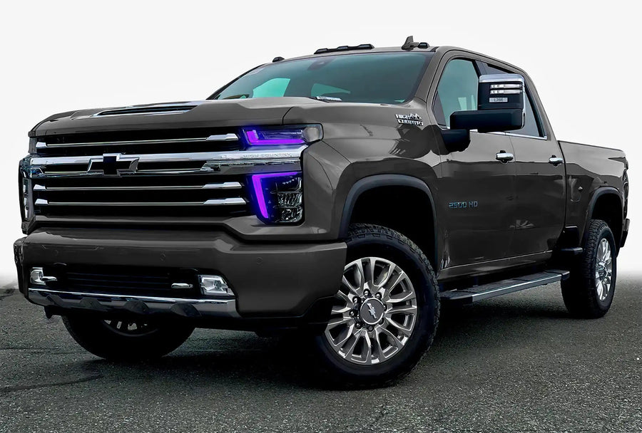 Three quarters view of a Chevy Silverado with purple headlight DRLs.