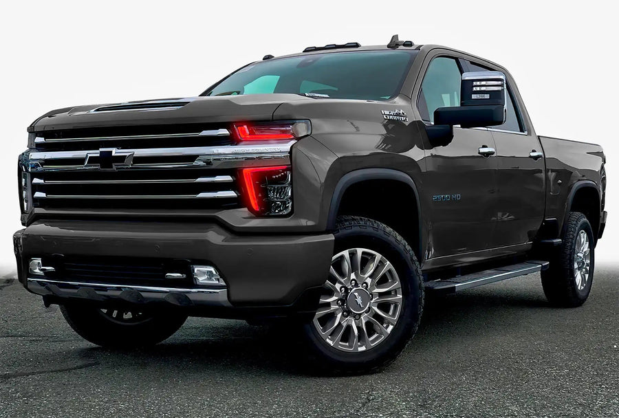 Three quarters view of a Chevy Silverado with red headlight DRLs.