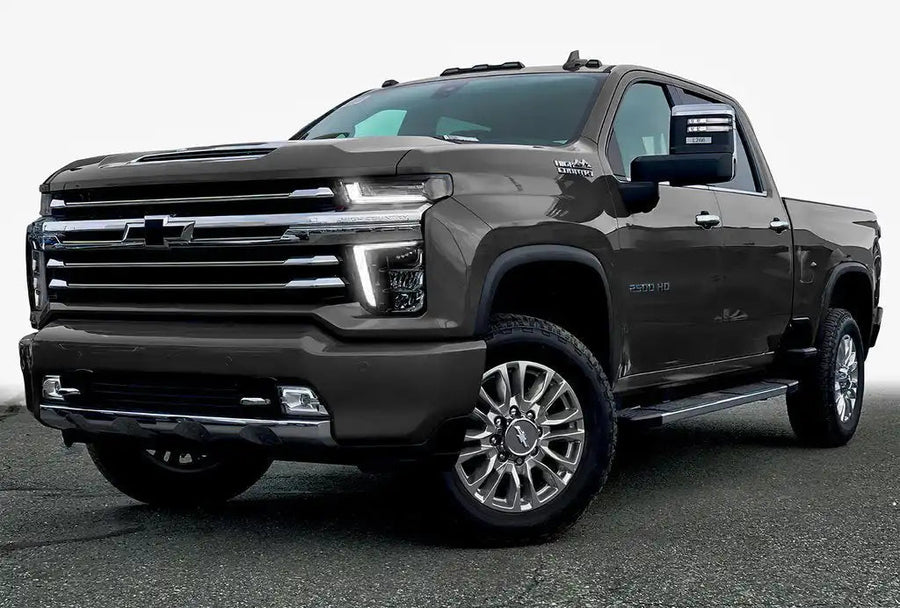 Three quarters view of a Chevy Silverado with white headlight DRLs.