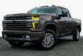 Three quarters view of a Chevy Silverado with yellow headlight DRLs.