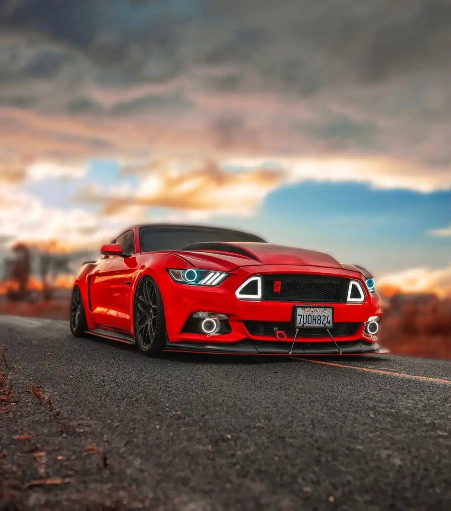 Three quarters view of a Ford Mustang with white LED headlight halos and DRLs.